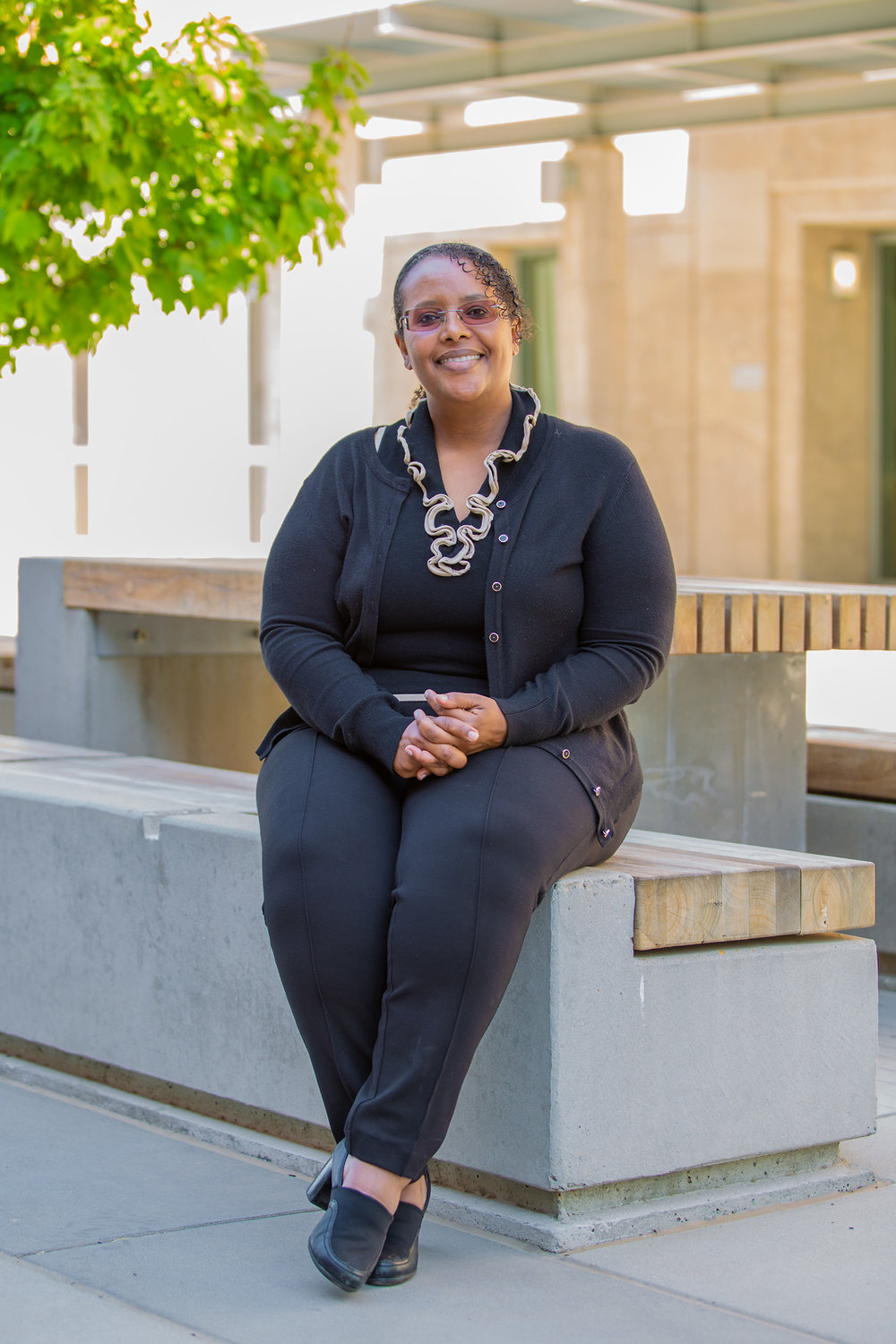 Asmeret Asefaw Berhe sitting on a bench on the CSU Merced campus.