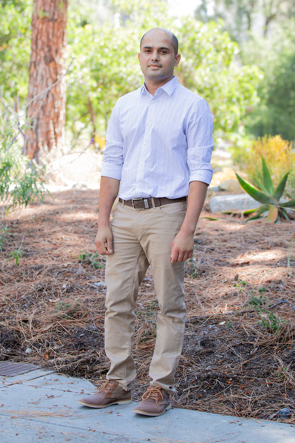 Surendra Adhikari standing in front of trees on the JPL campus.