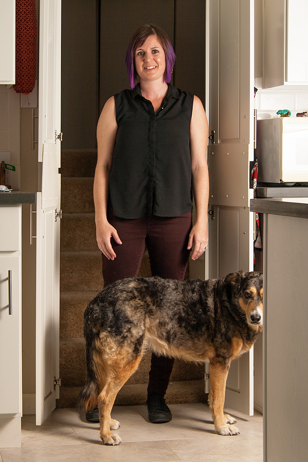 Jamie Louise Molaro standing with Phoebe the dog.