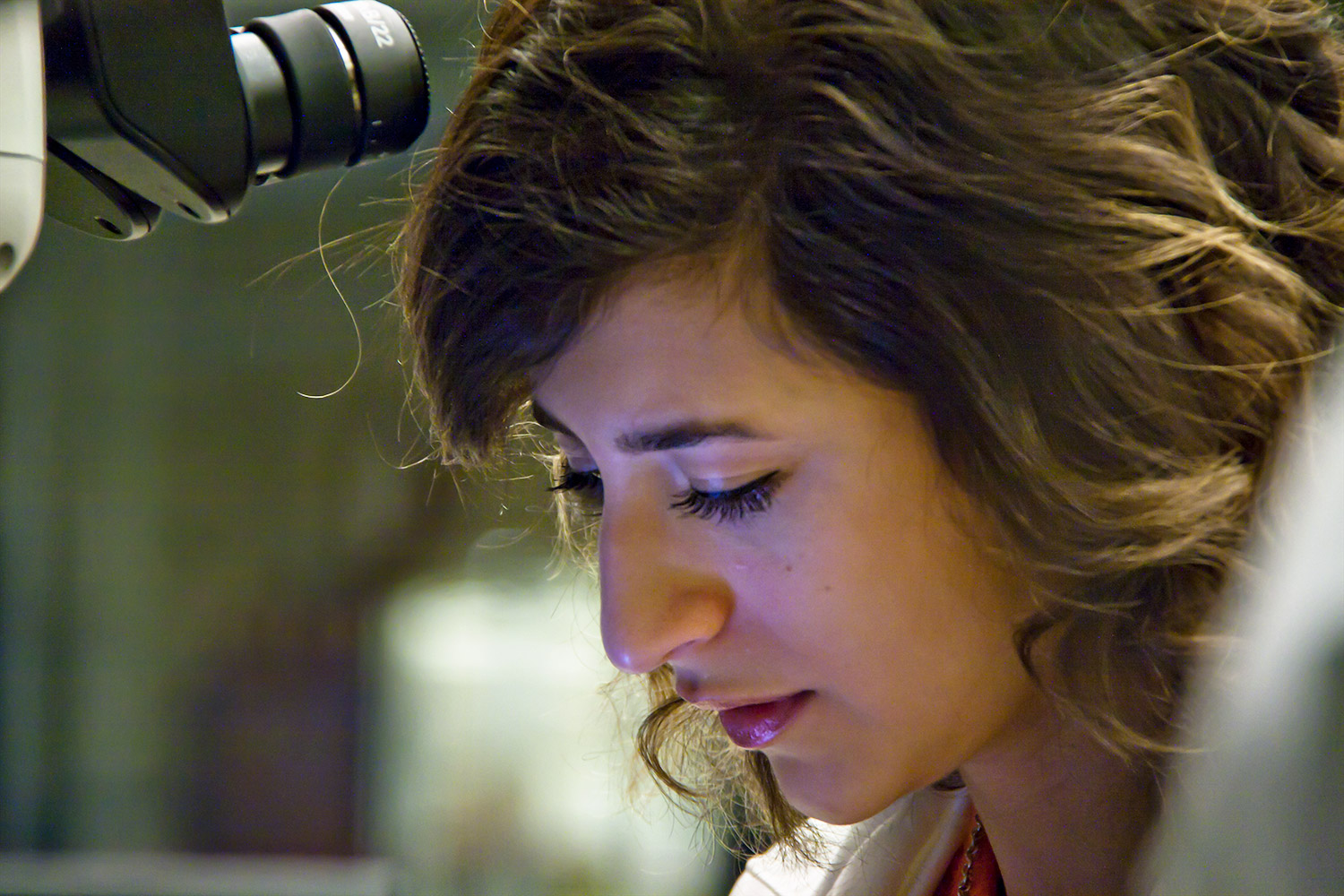 Hannah Shamloo peering into a microscope in the EPIC laboratory at ASU.